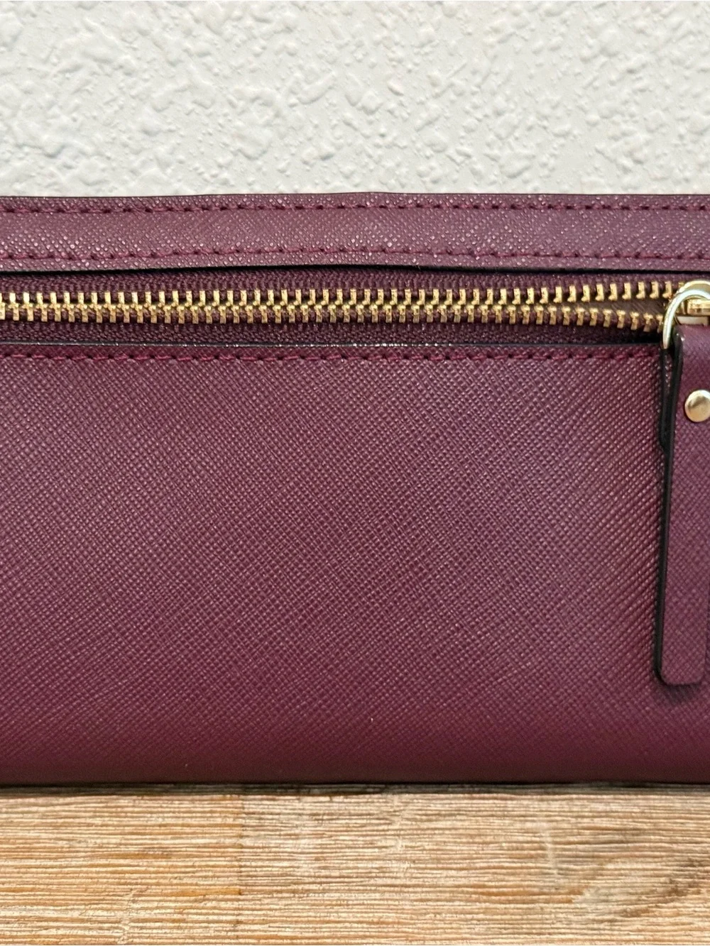 kate spade plum Saffiano leather long wallet with gold-tone plaque